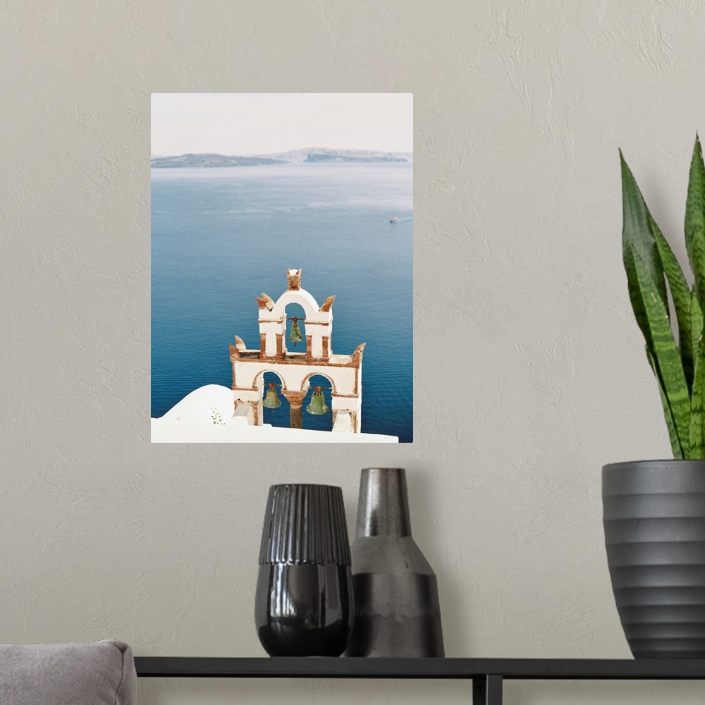 A modern room featuring Photograph of church bell towers overlooking the ocean in the Greek city of Oia, Santorini.