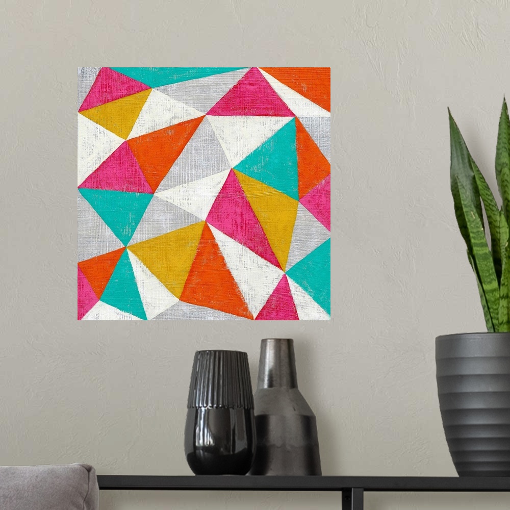 A modern room featuring Abstract geometric art in bright candy colored triangles.