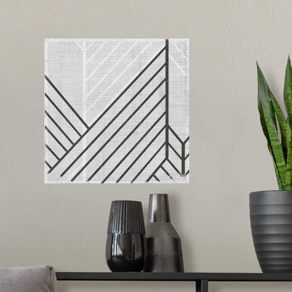 A modern room featuring Square abstract art with lines running diagonally across the canvas in gray and white.