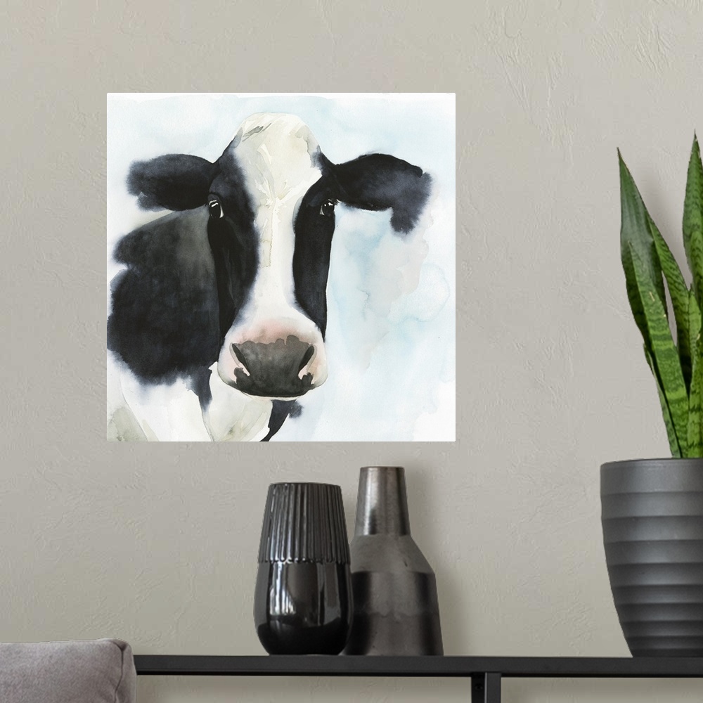 A modern room featuring A watercolor portrait of a black and white cow with pink and blue accents.