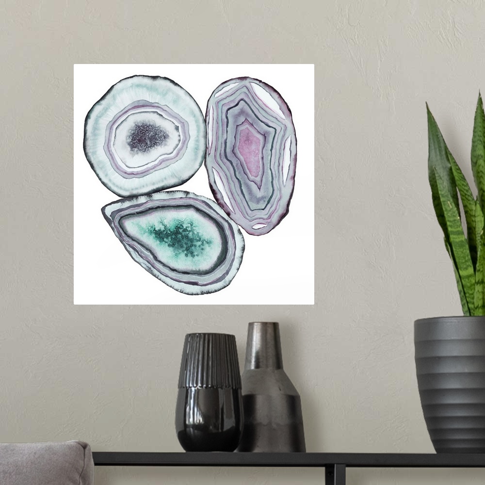 A modern room featuring Square watercolor artwork of geode rocks in green, purple and blue on a white background.