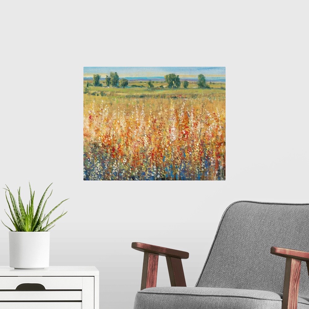 A modern room featuring Contemporary artwork of a field of yellow and red flowers with a green meadow in the distance.