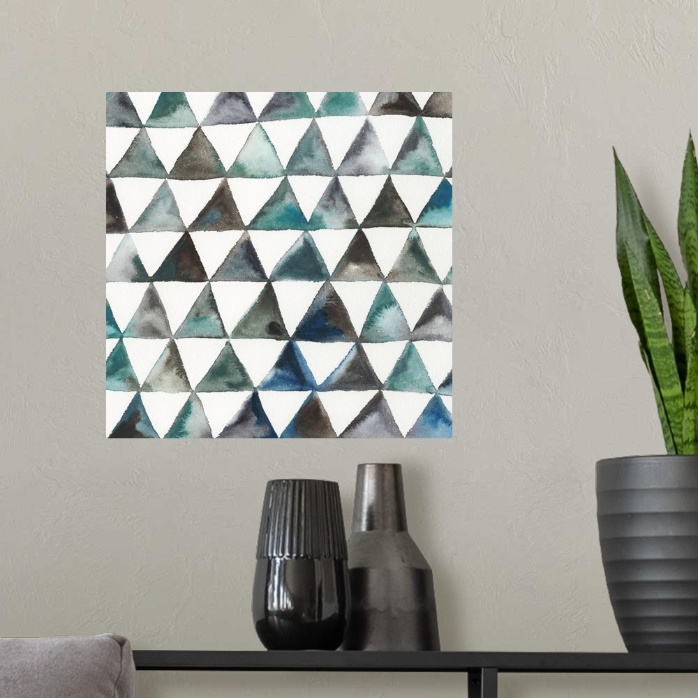 A modern room featuring Square abstract decor with triangles in lines creating a pattern in shades of blue, green, and br...