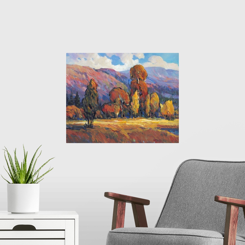 A modern room featuring Contemporary painting of a mountain valley landscape with a grove of trees in the fall.