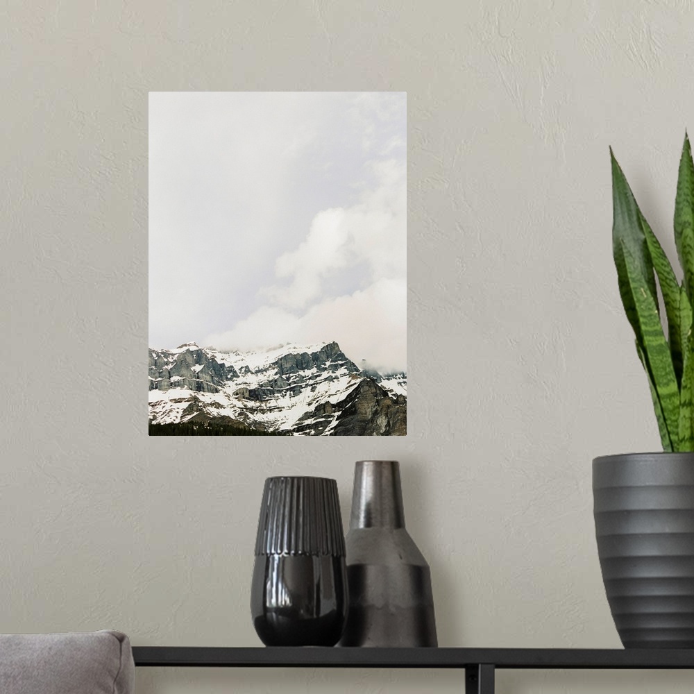 A modern room featuring Photograph of craggy mountains under a cloudy sky, Banff, Canada