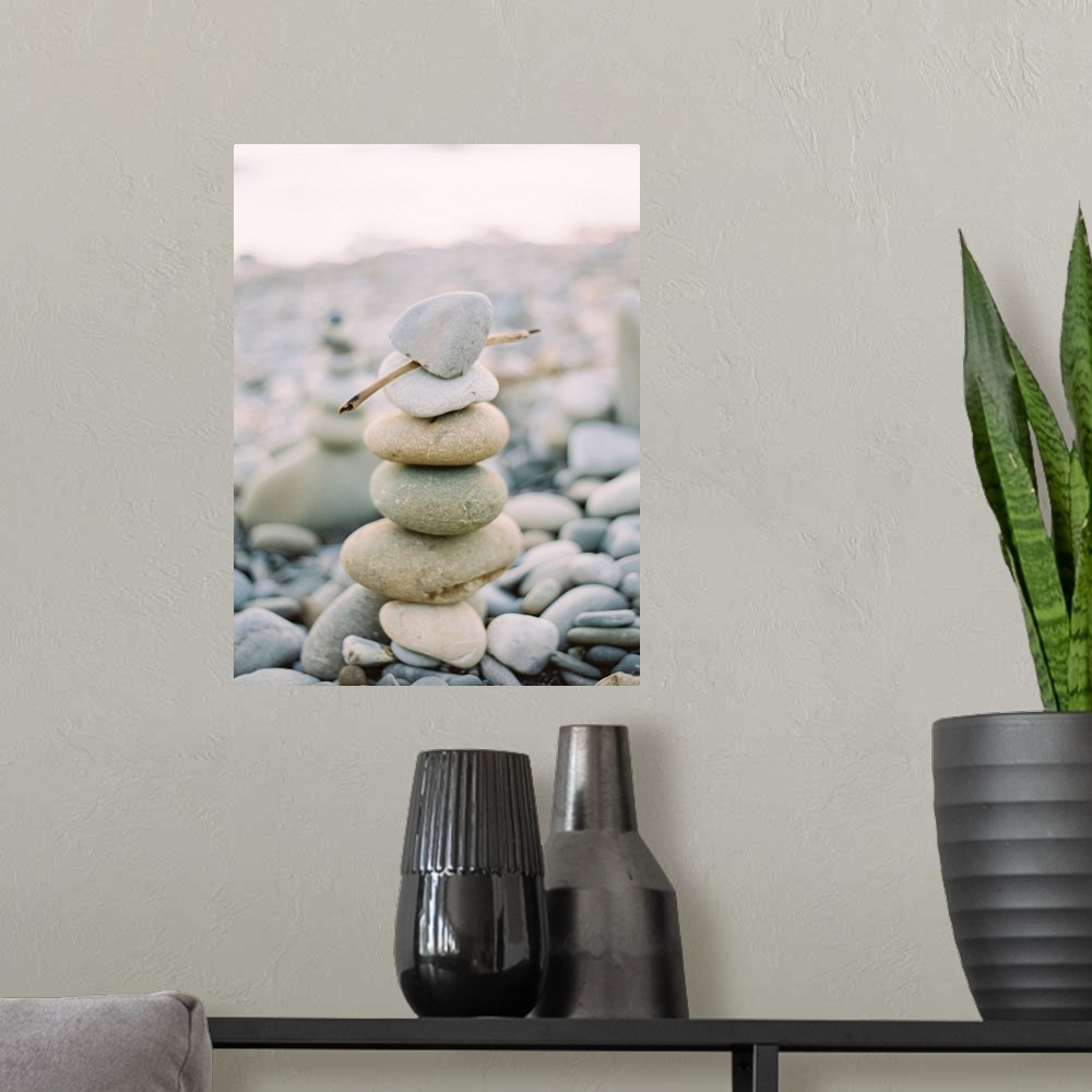 A modern room featuring Photograph of stack of small pebbles on the beach, California.
