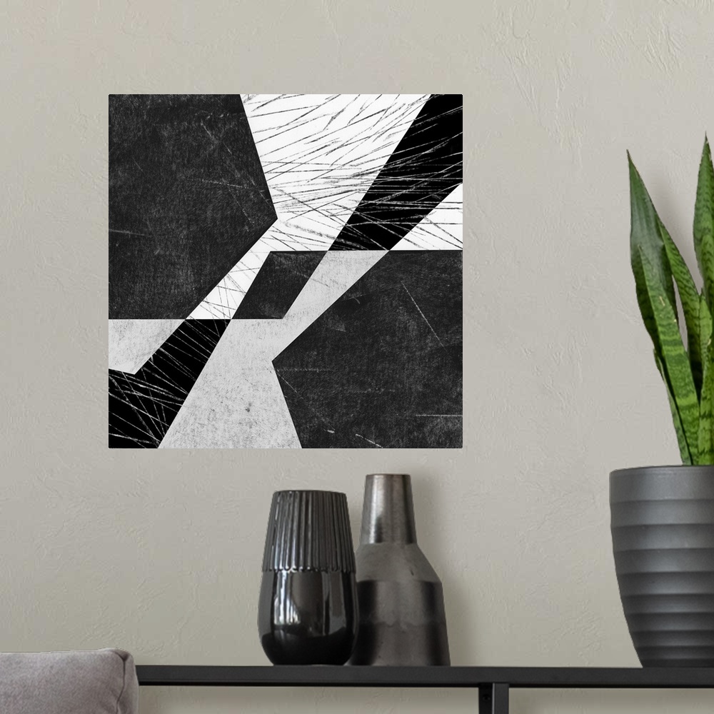 A modern room featuring Black and white geometric abstract painting on a square background.