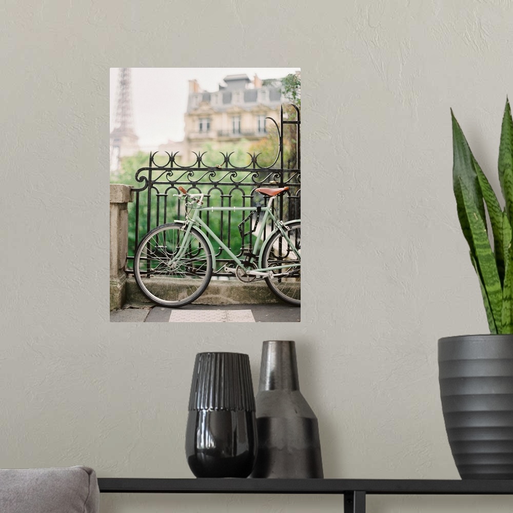 A modern room featuring Photograph of a bicycle leaning against an ornate metal railing with the Eiffel tower in the dist...
