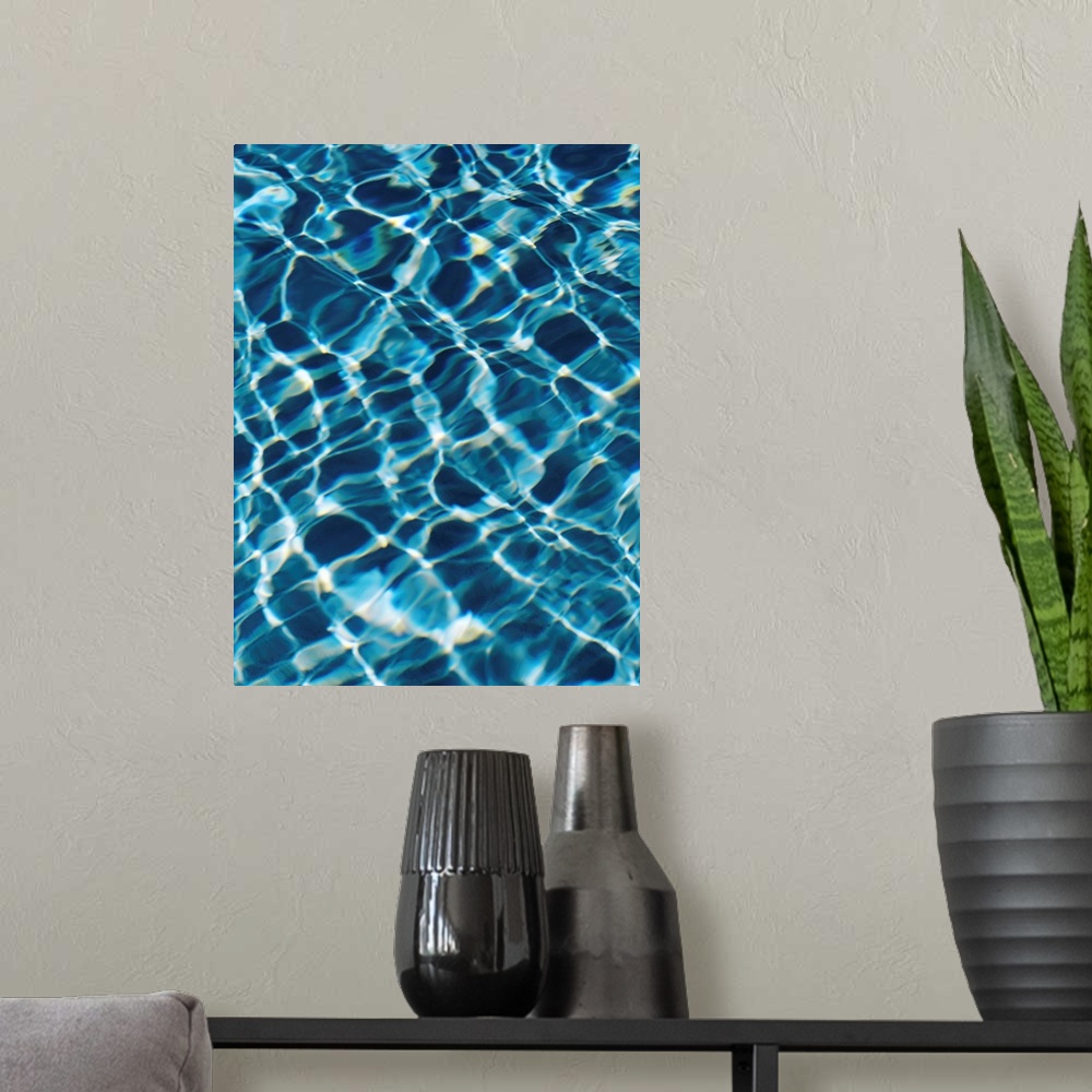 A modern room featuring An abstracted photograph of sunlight reflecting off of clear pool water.