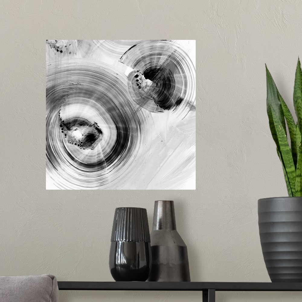 A modern room featuring Contemporary abstract painting of circular forms in white and black reminiscent of water's ripple...