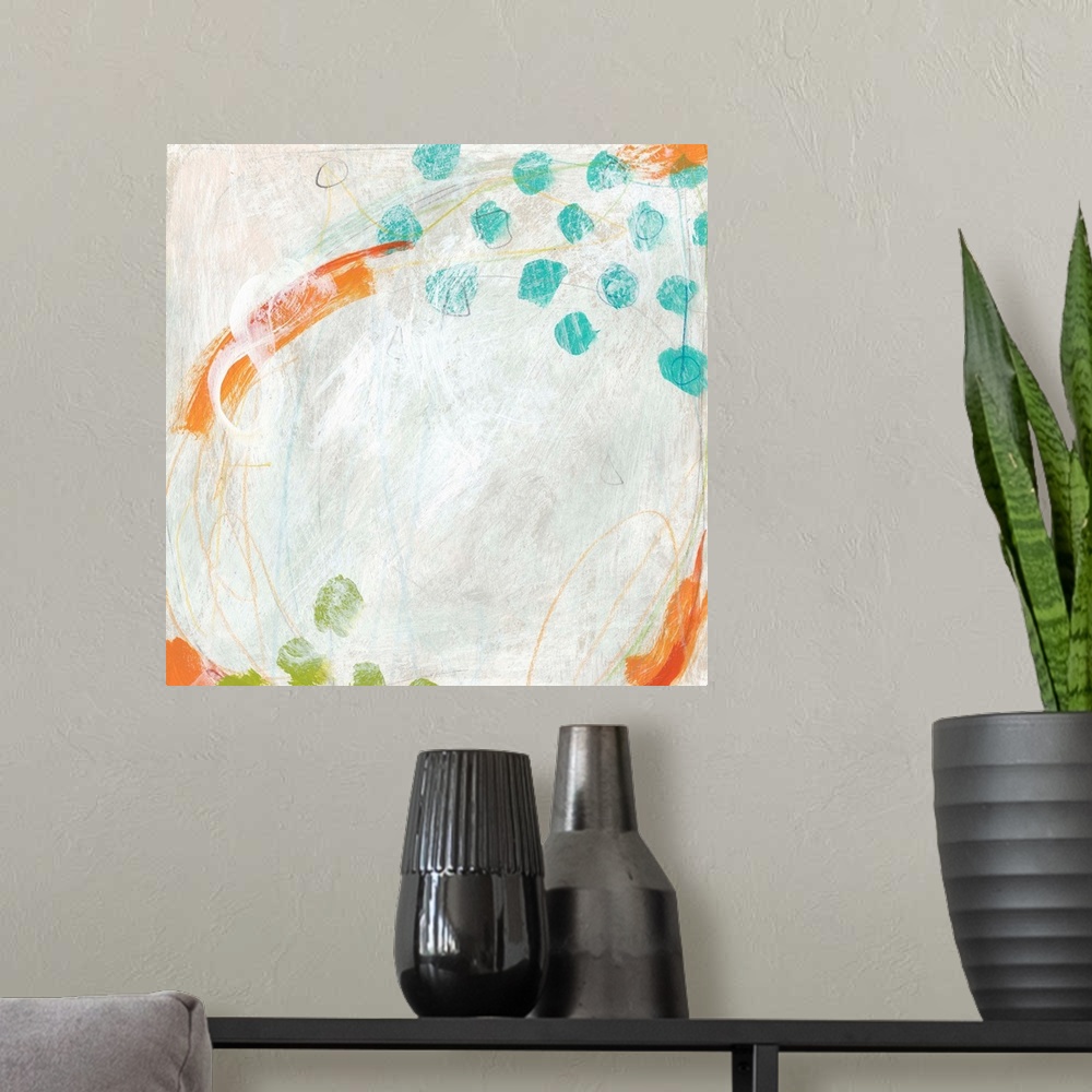 A modern room featuring Abstract painting with bright blue and green dots on a pale background.