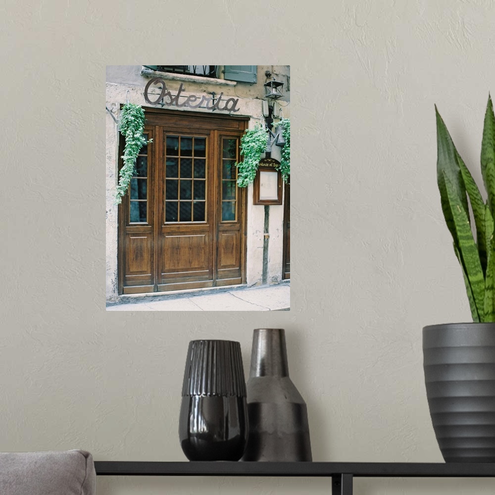 A modern room featuring A photograph of the doors of a rustic mediterranean cafe.