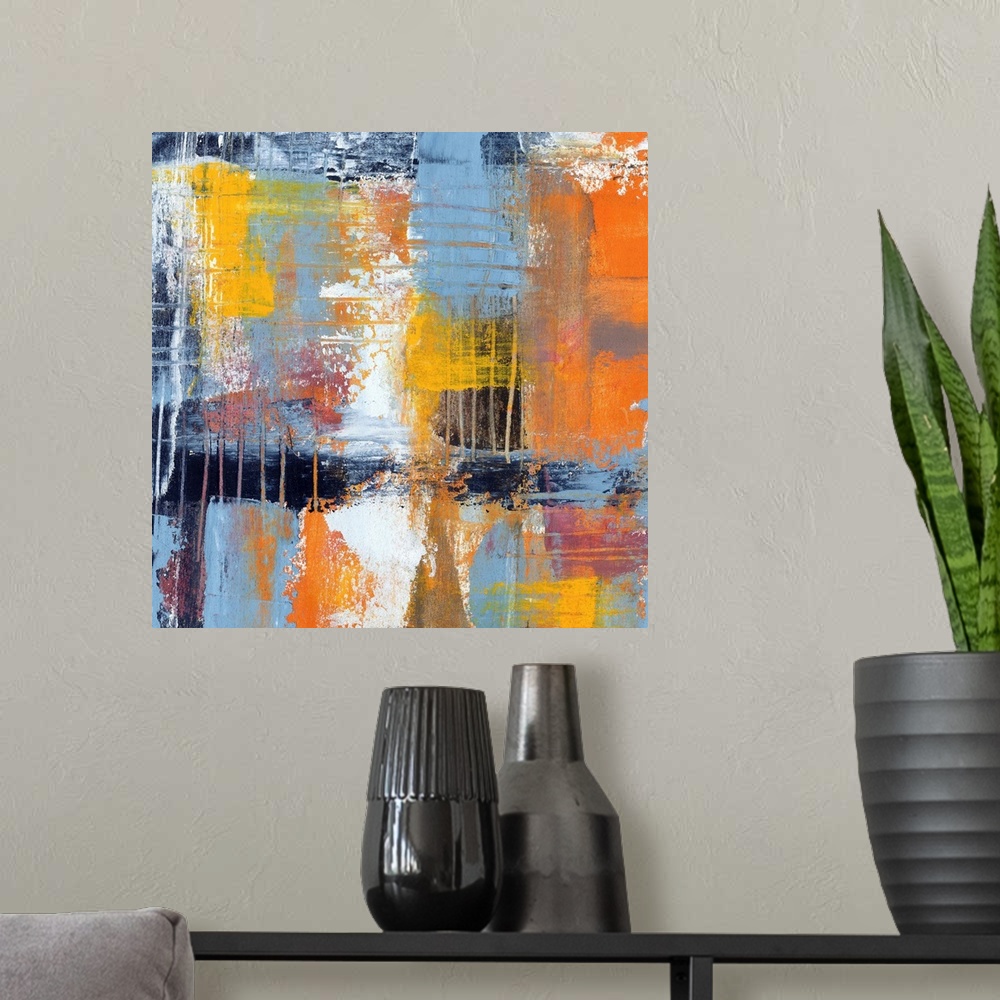 A modern room featuring Colorful contemporary abstract painting using muted blue orange and yellow tones.