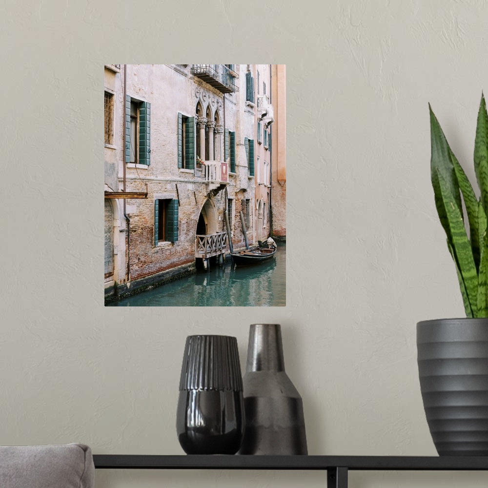 A modern room featuring A photograph of the facade of a house on a canal, Venice, Italy.