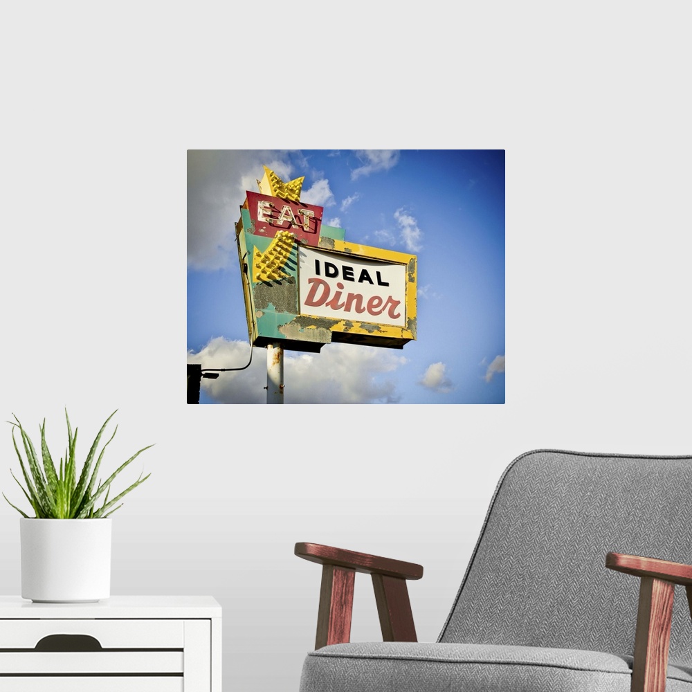 A modern room featuring Photograph of a retro restaurant sign against a cloudy blue sky.
