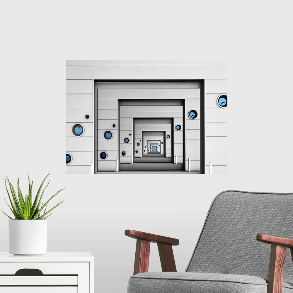 A modern room featuring Conceptual image of a wall with blue portholes infinitely repeating itself.