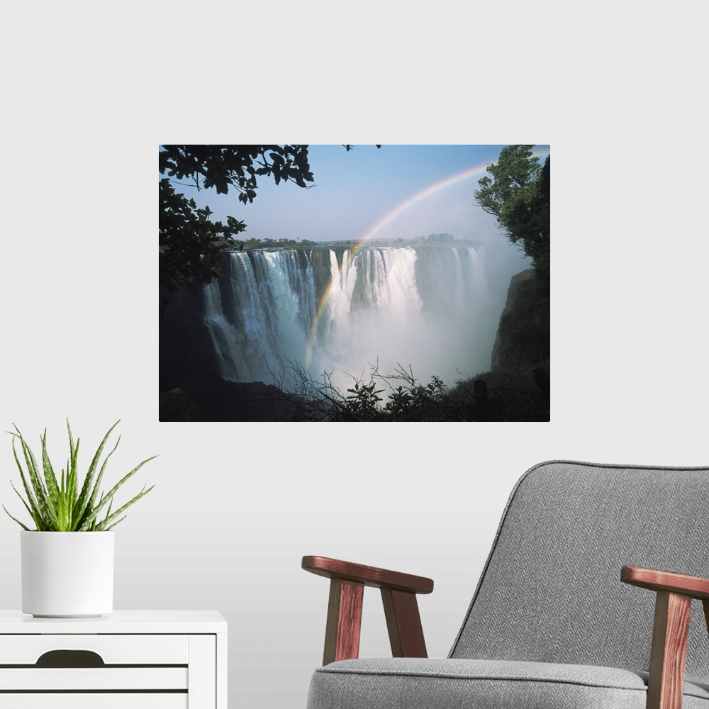 A modern room featuring Rainbow In Front Of Victoria Falls; Zimbabwe