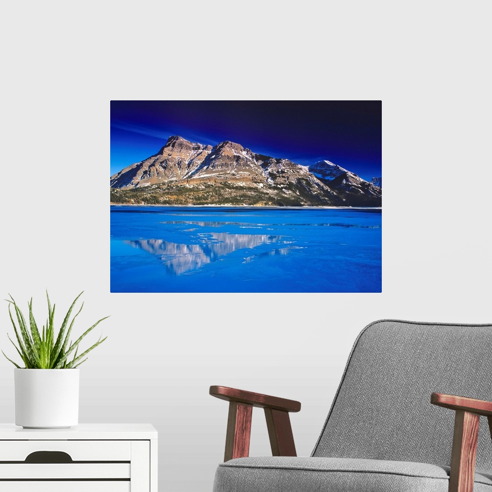 A modern room featuring Upper Waterton Lake in winter in Waterton lakes National Park in Alberta Canada