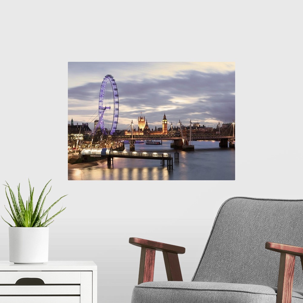 A modern room featuring Millenium Wheel, London Eye and Big Ben viewed over the river Thames