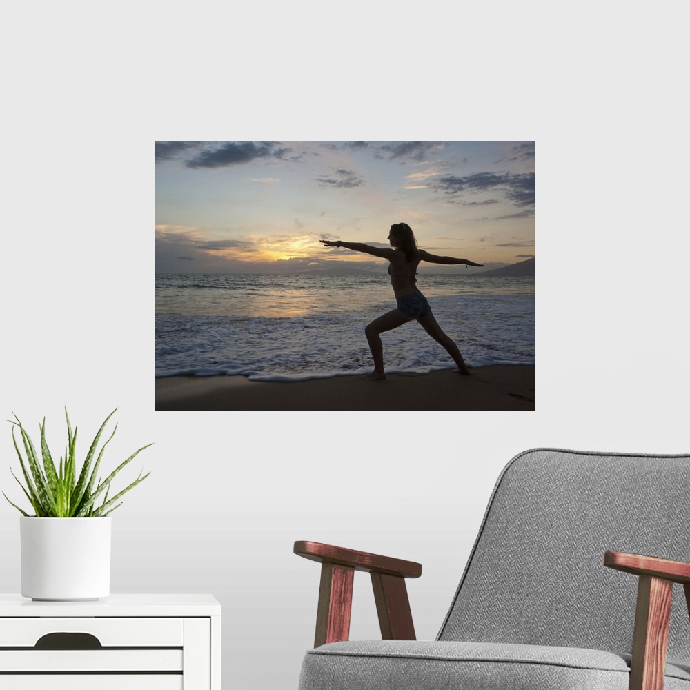 A modern room featuring Mixed race woman practicing yoga on beach