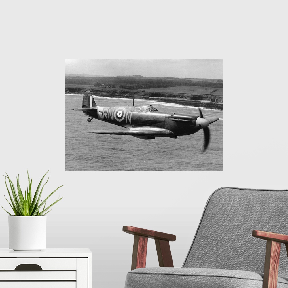 A modern room featuring A Spitfire in flight of the coast of Britain during World War II.