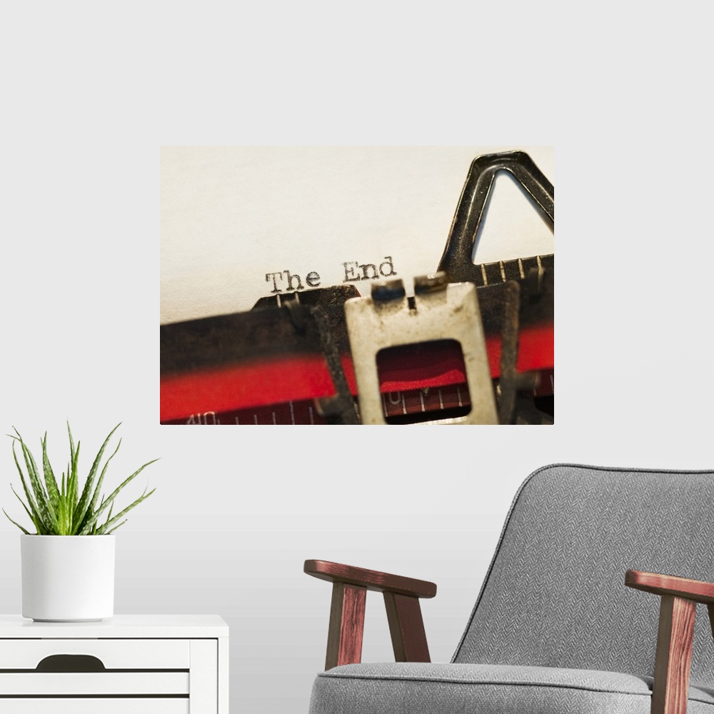 A modern room featuring This picture was taken closely zoomed in on a typewriter that had just written "The End" onto a b...