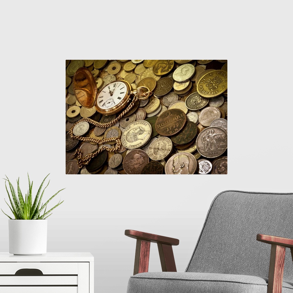 A modern room featuring A collection of coins with a gold pocketwatch.