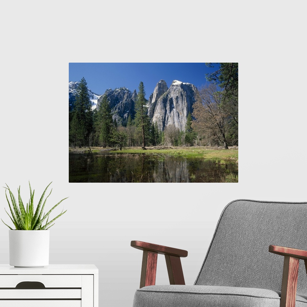 A modern room featuring Lake reflecting trees and the Cathedral Rocks in the Yosemite National Park, California