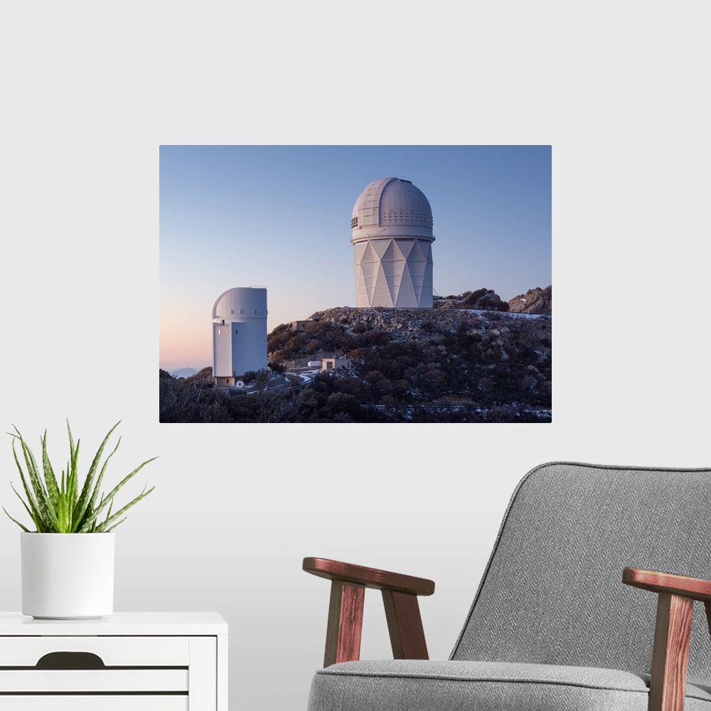 A modern room featuring The Mayall Observatory sits atop Kitt Peak at sunset, Arizona.
