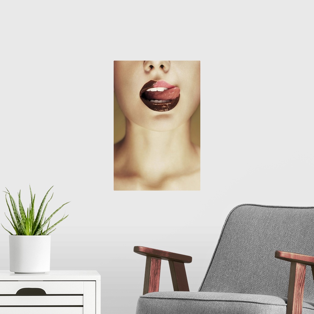 A modern room featuring A woman licking chocolate off of her lips with her tongue.