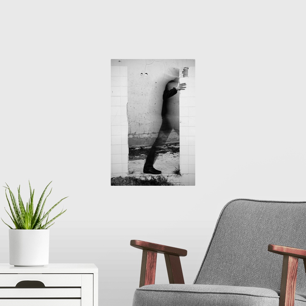 A modern room featuring Conceptual photograph of a male figure stepping through a wall.