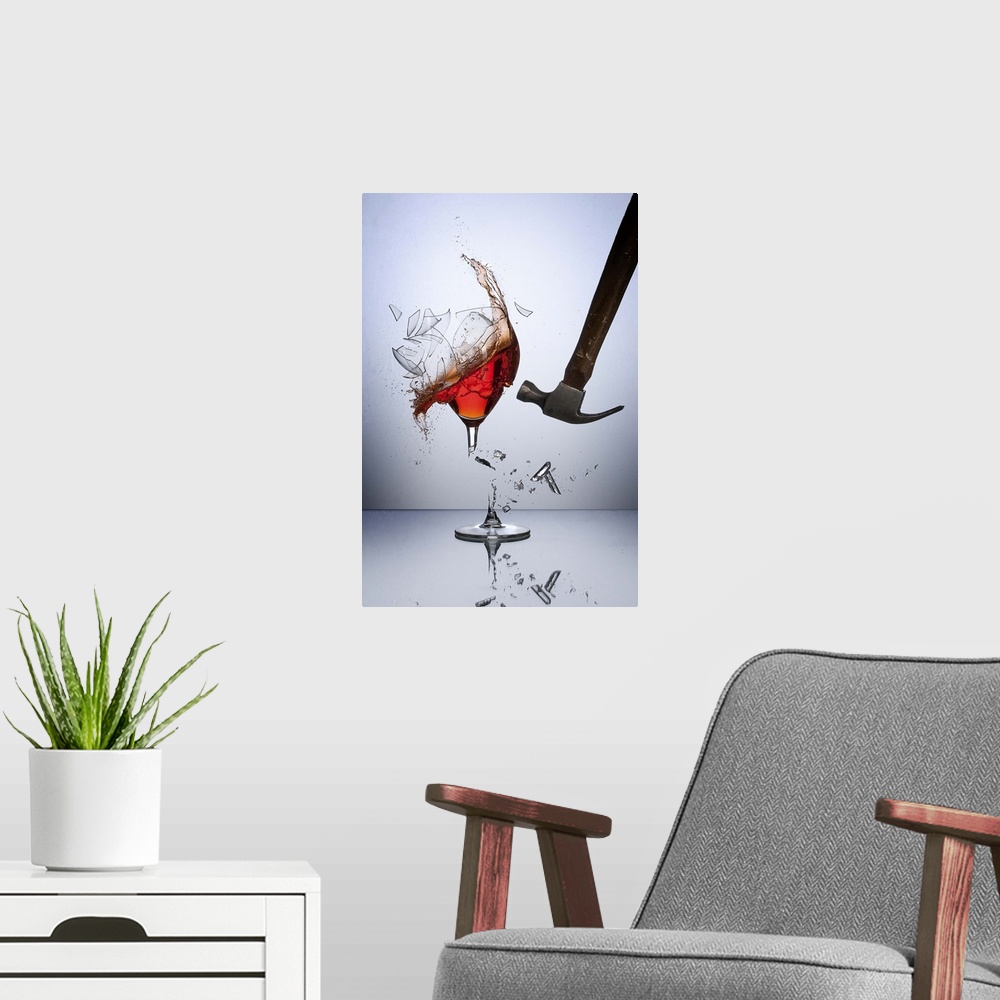 A modern room featuring A hammer smashing a glass of wine, sending glass shards flying.