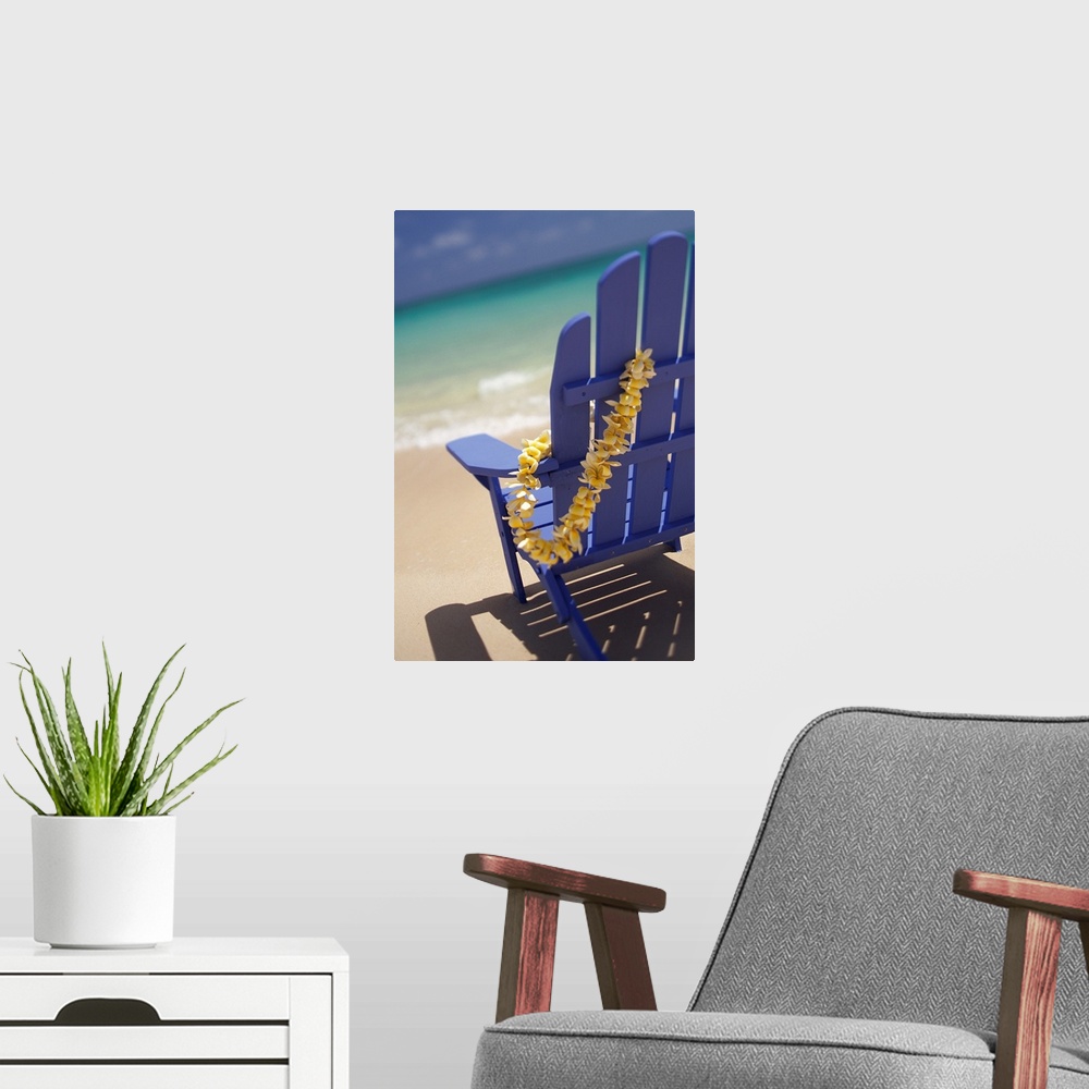 A modern room featuring Blue Beach Chair With Plumeria Lei Hanging On Side