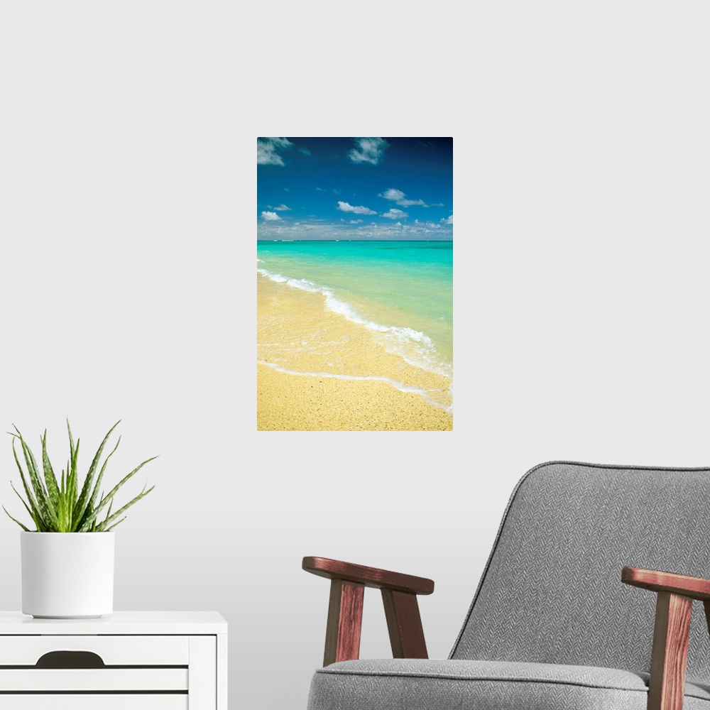 A modern room featuring Vertical photo on canvas of crystal clear waves washing up on shore of a beach.