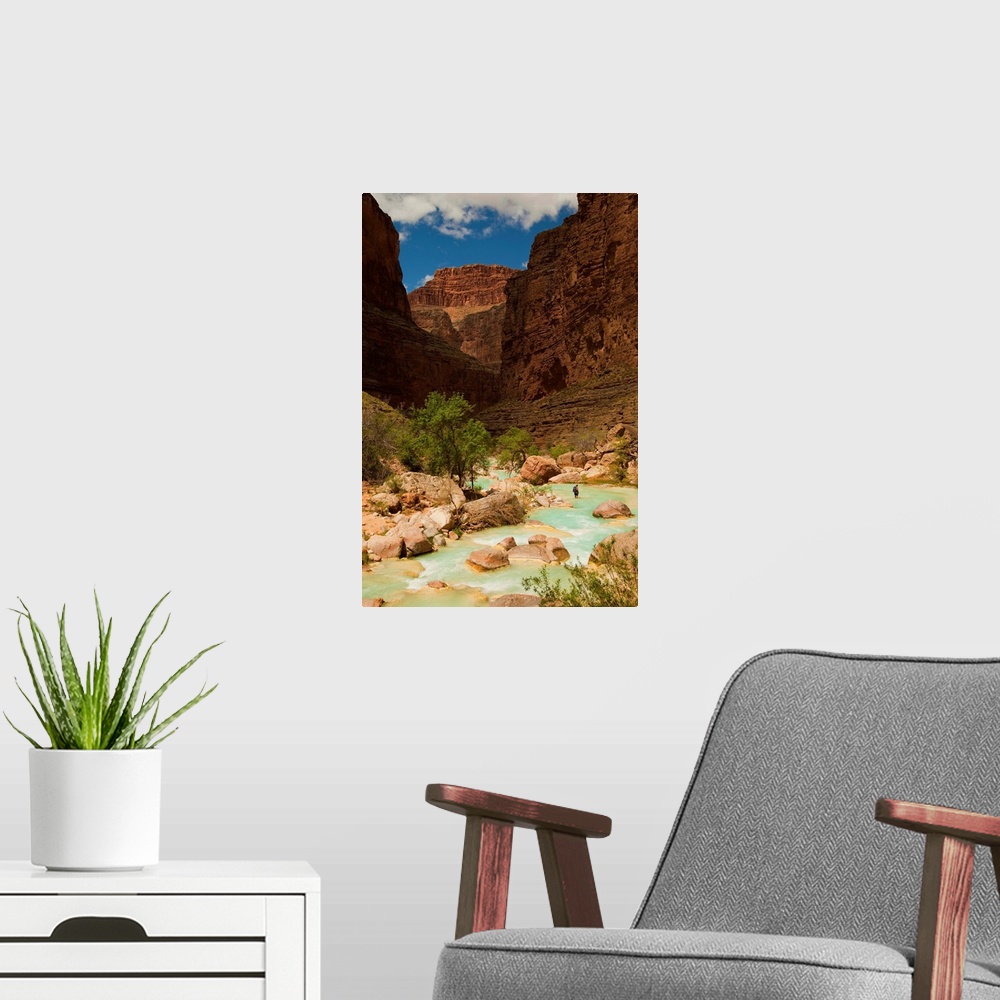 A modern room featuring Hiker walking in the turquoise waters of Havasu Canyon.
