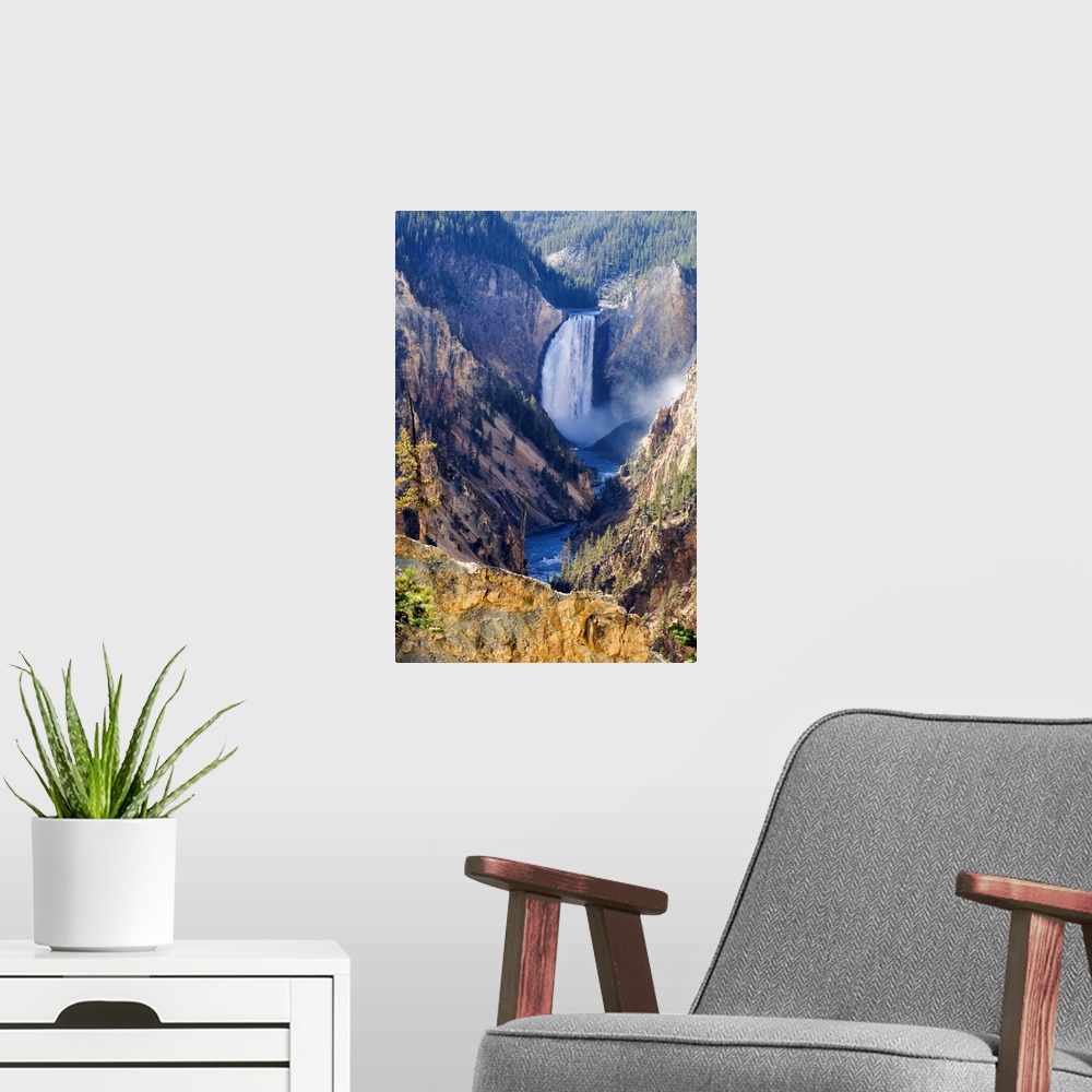 A modern room featuring Sunlit sulphuric rock of the cliffs surrounding the Lower Falls of the Yellowstone River in the G...