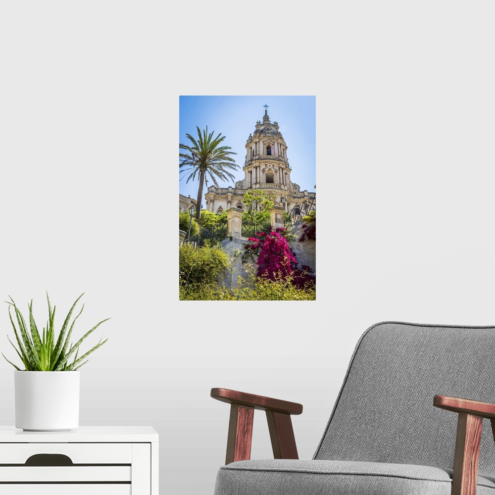 A modern room featuring The dome of the baroque Cathedral of San Giorgio with gardens in historical Modica in the Provnic...