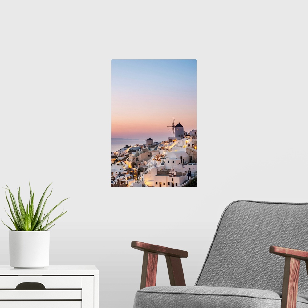 A modern room featuring Whitewash buildings and windmill at dusk; Oia, Santorini, Greece