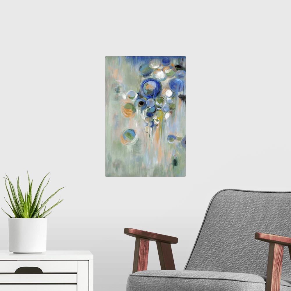A modern room featuring Home decor abstract artwork of blue circles of different sizes against a pale green background.