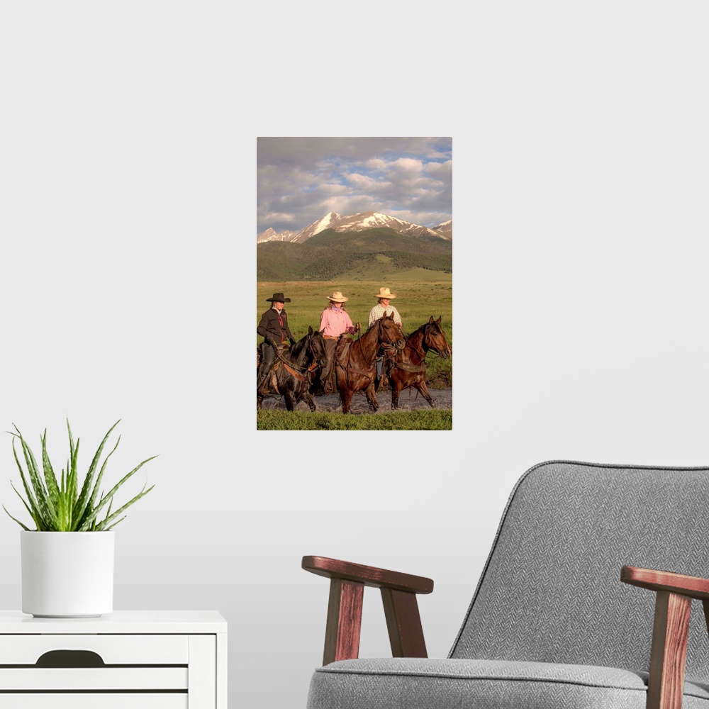 A modern room featuring Photograph of three cowgirls on horseback crossing a river.