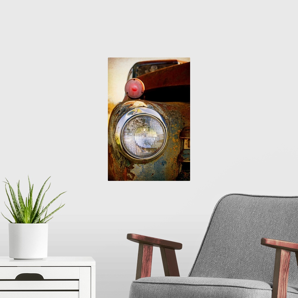 A modern room featuring Photograph of a headlight of on the front of a vintage car.