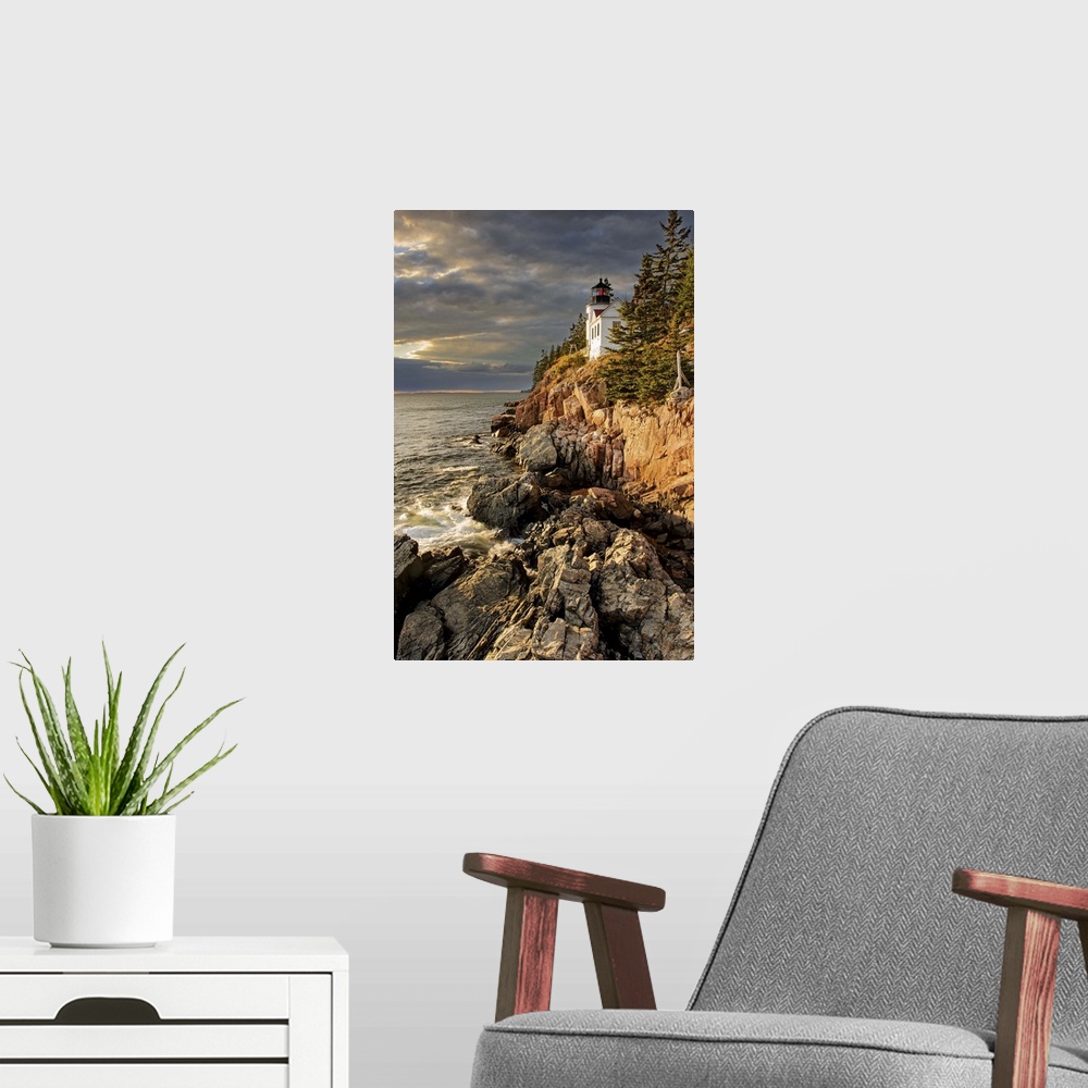 A modern room featuring A photograph of a lighthouse on a rocky escarpment on the coastline.