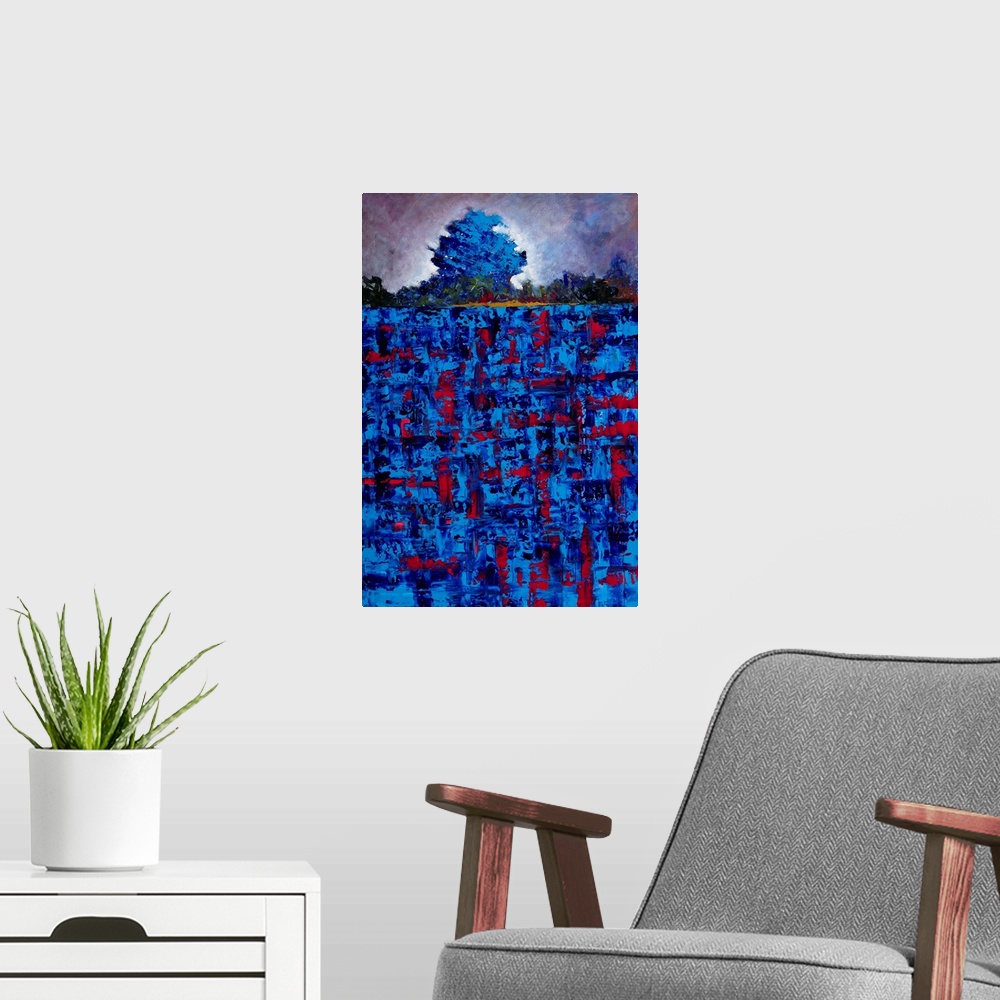 A modern room featuring Abstract landscape created with vibrant blue and red hues of a single tree in a field.