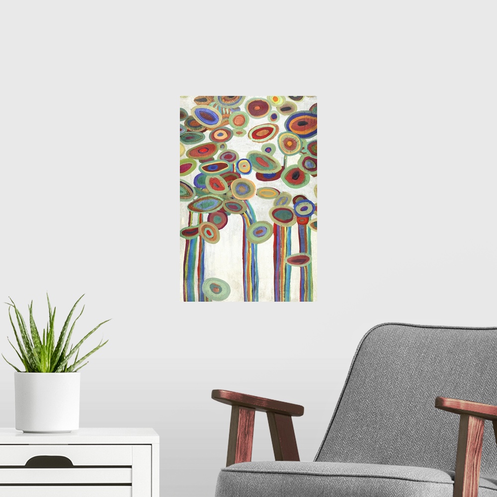 A modern room featuring Vertical painting of a group of multi-colored circles against a neutral backdrop.