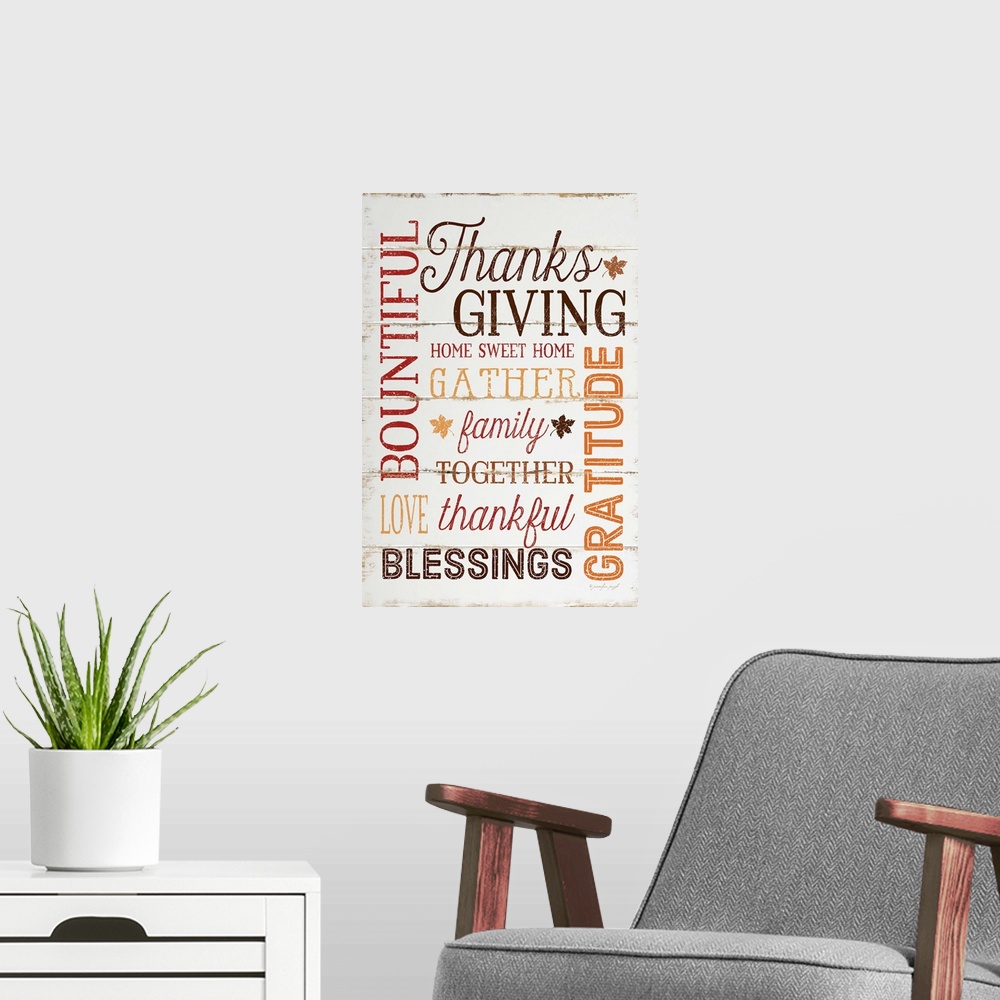 A modern room featuring Thanksgiving themed typography artwork in festive fall colors against a rustic wooden background.