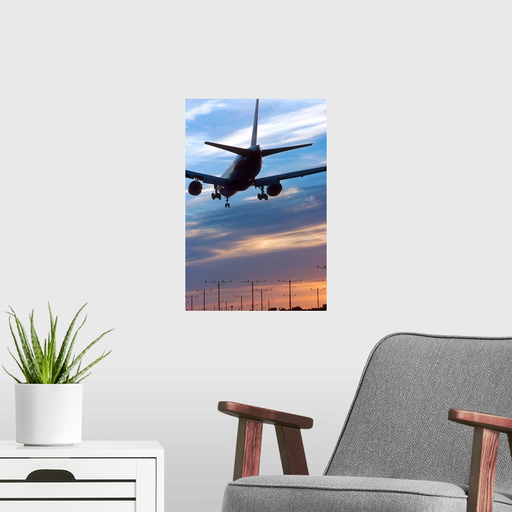 A modern room featuring Airplane landing at LAX airport in Los Angeles, California at sunset.