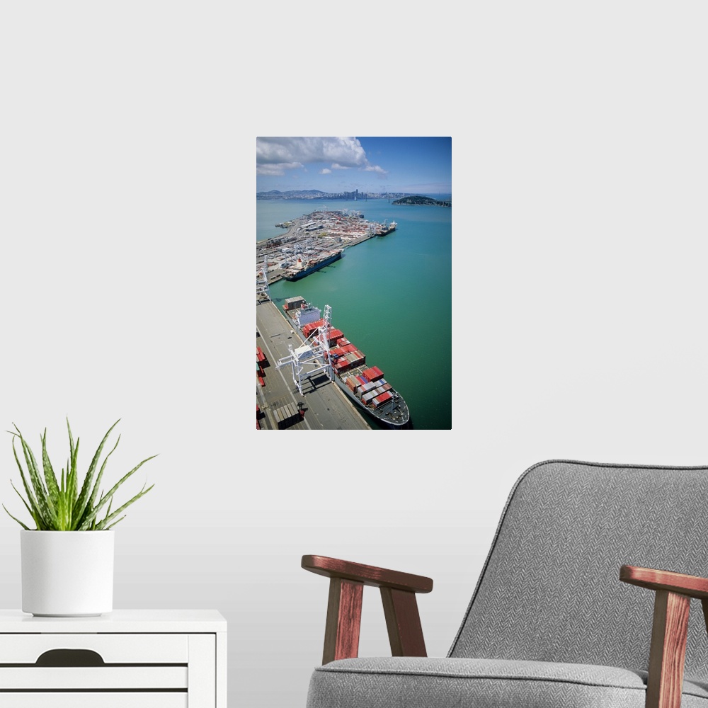 A modern room featuring Container ship being loaded at the port of Oakland, California.