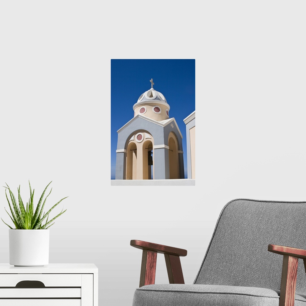 A modern room featuring Europe, Greece, Santorini. Peach and grey church bell tower against clear blue sky.
