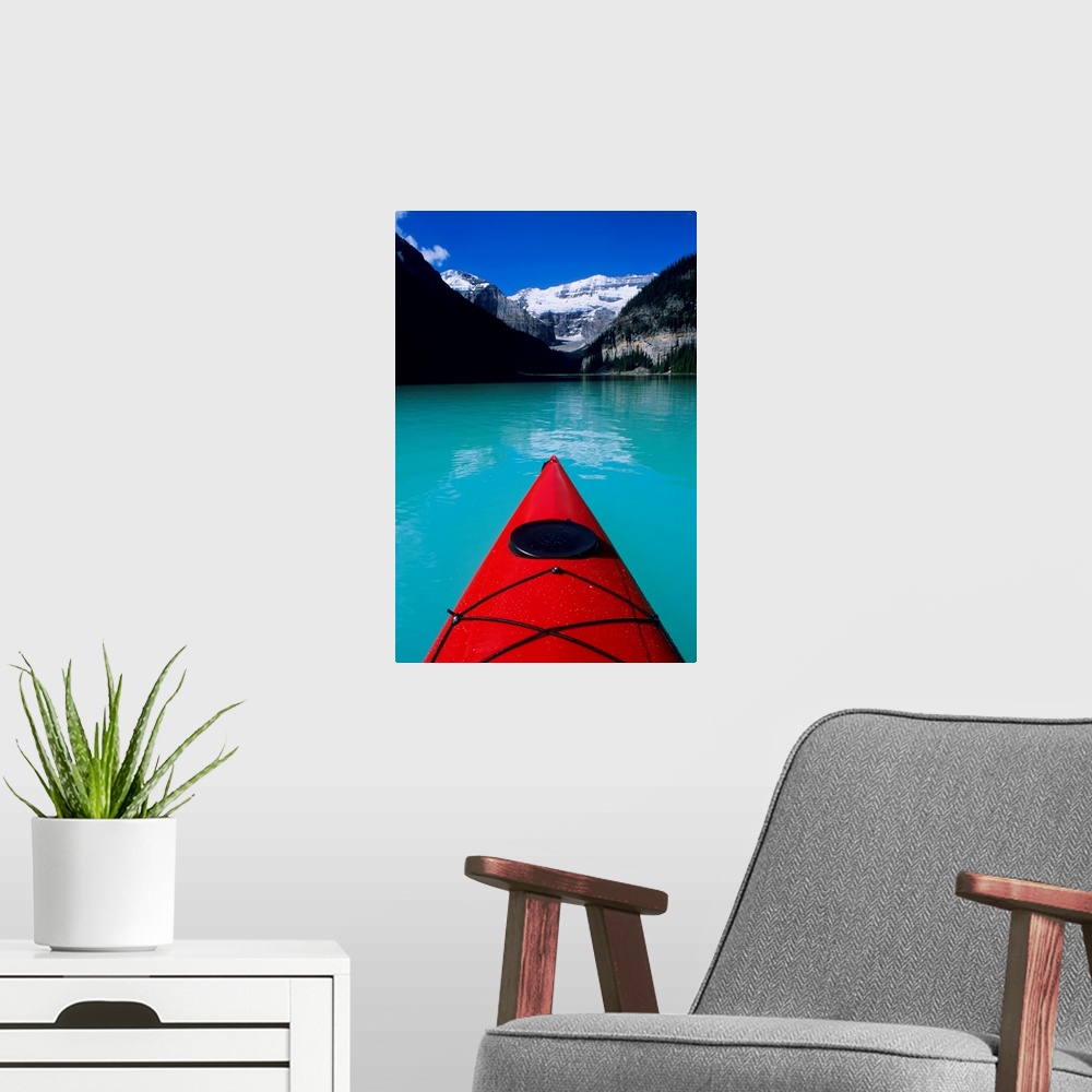 A modern room featuring Kayak on Lake Louise below Mount Victoria in the Canadian Rockies; Banff National Park; Alberta, ...