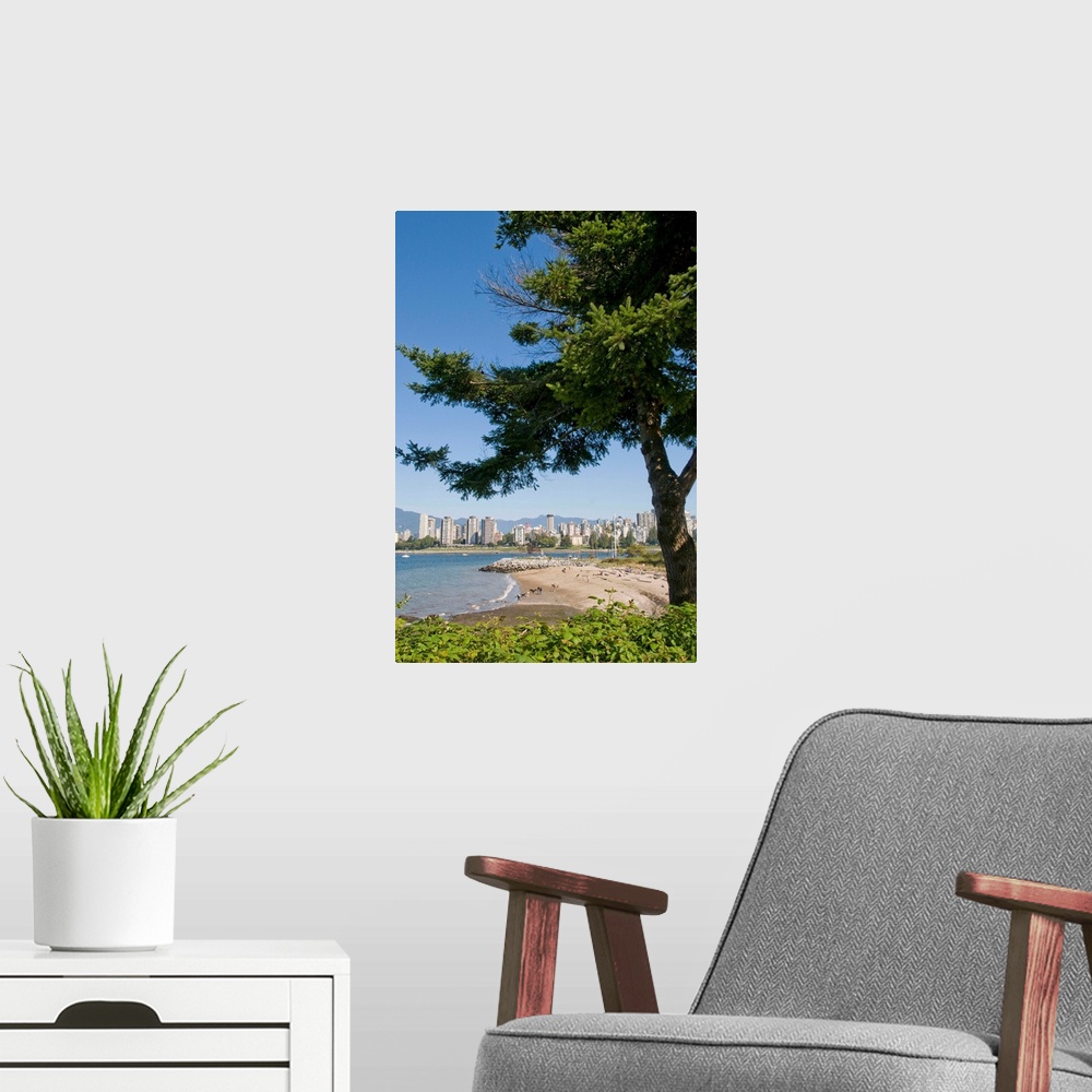 A modern room featuring Kitsilano Beach park overlooking English Bay and the skyline of downtown Vancouver, BC, Canada.
